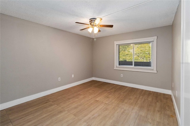 spare room with ceiling fan, a textured ceiling, and light wood-type flooring