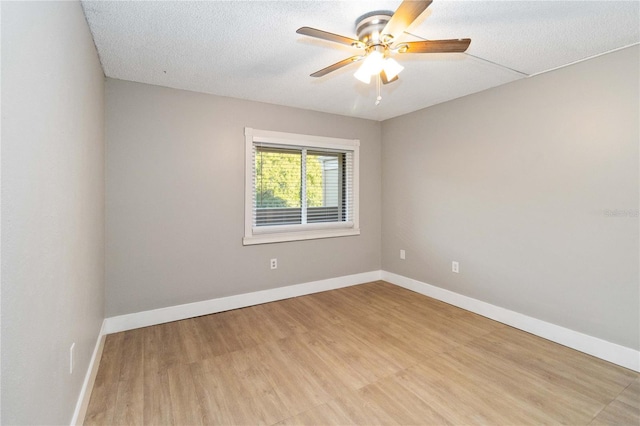 spare room featuring a textured ceiling, light hardwood / wood-style floors, and ceiling fan