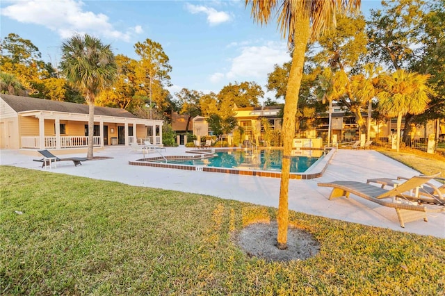 view of swimming pool with a lawn and a patio