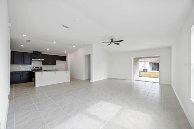 unfurnished living room with light tile patterned flooring, sink, and ceiling fan