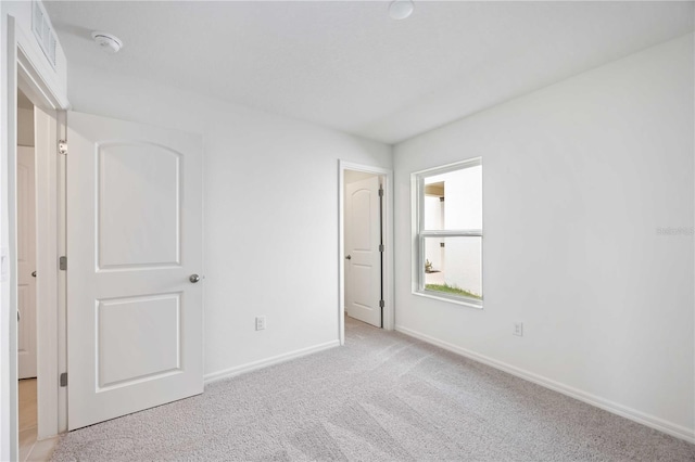 unfurnished bedroom with light carpet