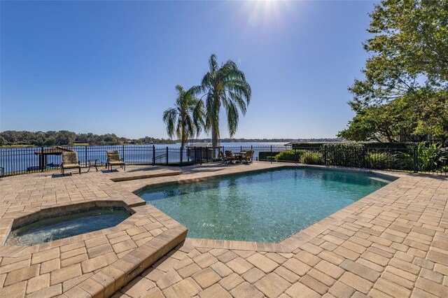 view of pool featuring an in ground hot tub and a patio