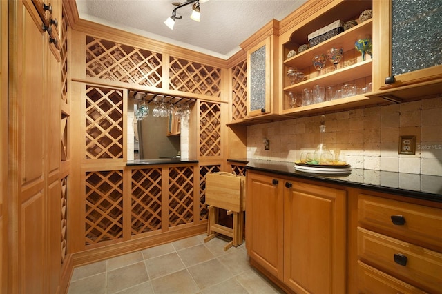 wine room featuring a textured ceiling and light tile patterned flooring