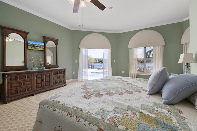 carpeted bedroom featuring access to outside, ceiling fan, and ornamental molding