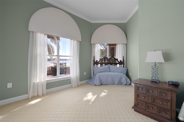 bedroom with light carpet and crown molding