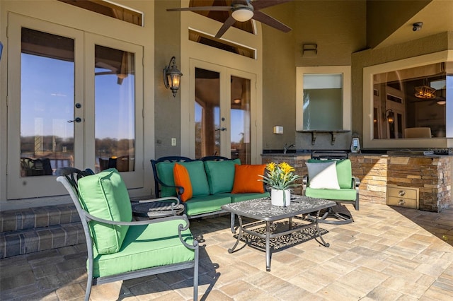 view of patio featuring ceiling fan, french doors, and an outdoor living space