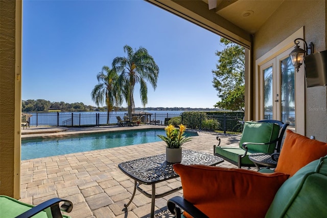 view of swimming pool with outdoor lounge area, french doors, and a patio