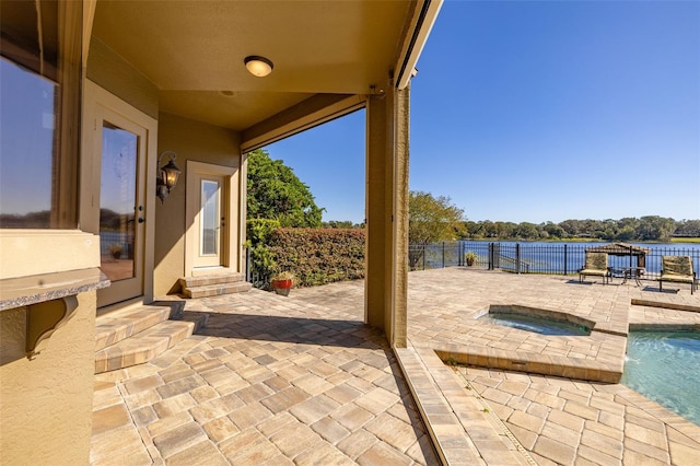 view of patio featuring a pool with hot tub