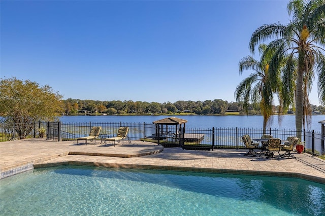 view of pool featuring a patio and a water view