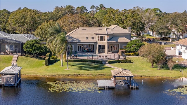 exterior space with a patio, a water view, a swimming pool, and a lawn