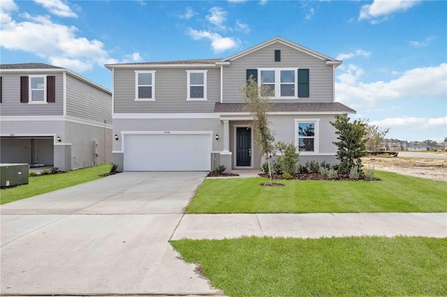 front of property with a front yard and a garage