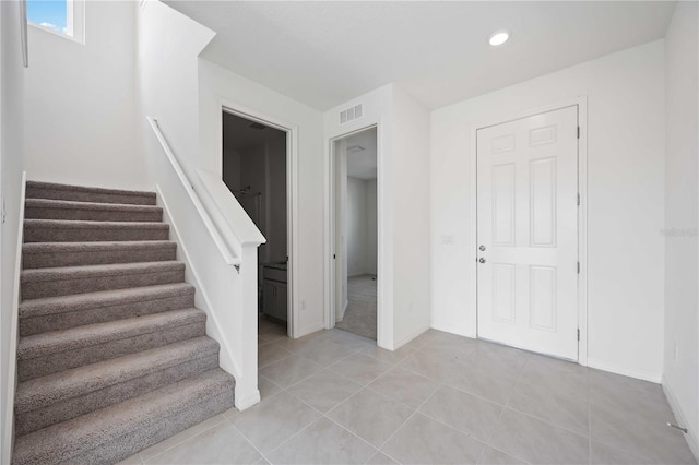 stairway featuring tile patterned floors