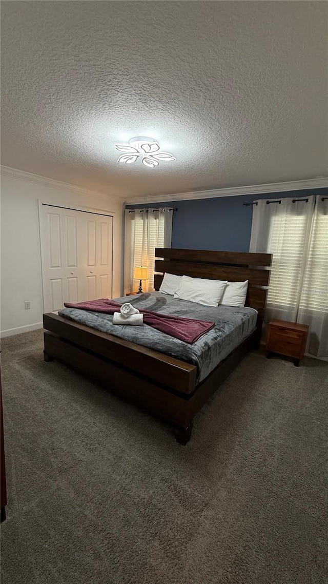 carpeted bedroom with a textured ceiling, a closet, and crown molding