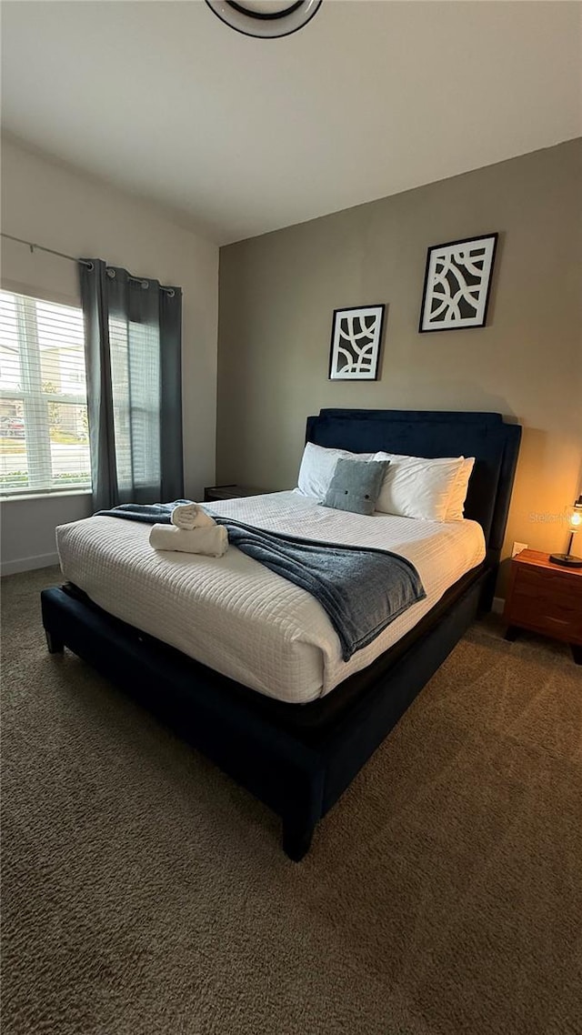 bedroom featuring dark colored carpet