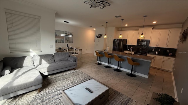 living room with light tile patterned floors and sink