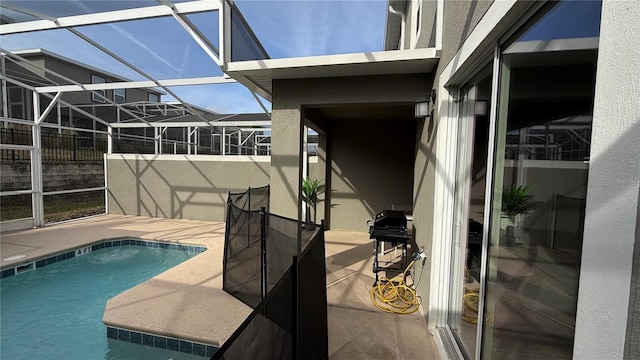 view of swimming pool with a lanai, a patio, and area for grilling