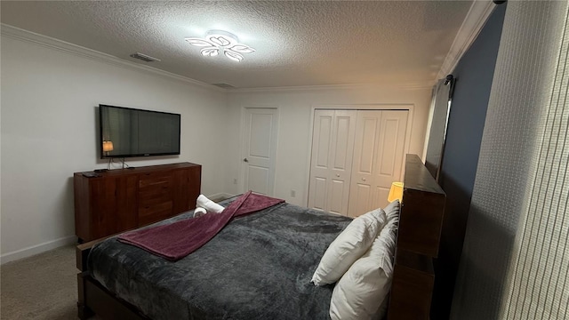 bedroom featuring a textured ceiling, a closet, carpet flooring, and crown molding