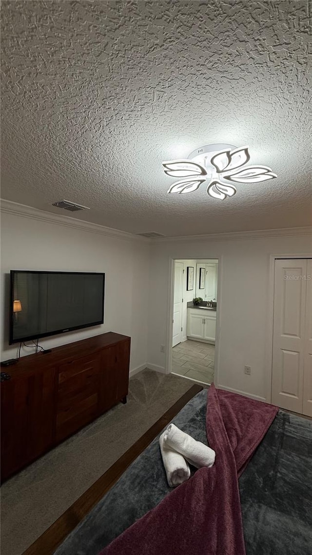 bedroom with light carpet, crown molding, and a textured ceiling