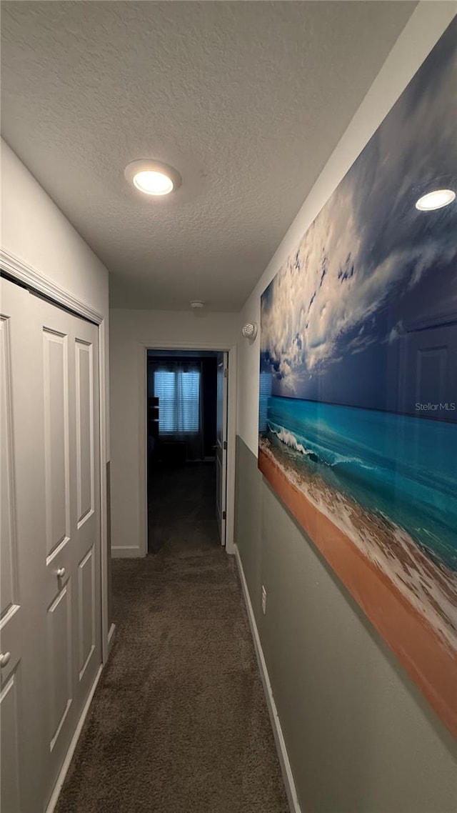 corridor with dark colored carpet