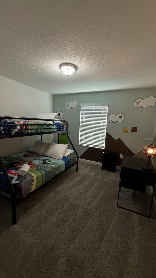 bedroom with a textured ceiling and carpet floors