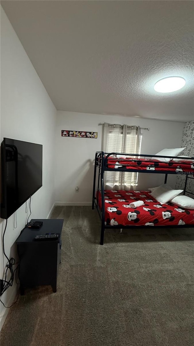 carpeted bedroom with lofted ceiling and a textured ceiling