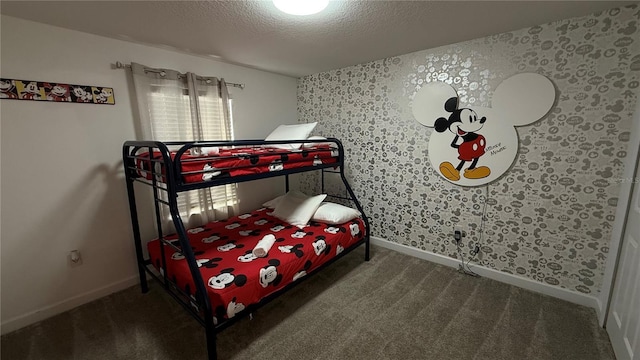 bedroom featuring a textured ceiling and dark colored carpet