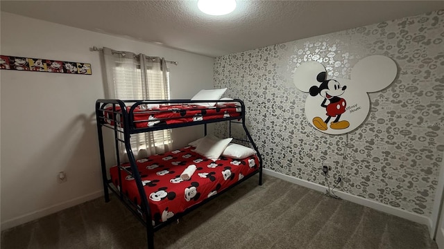 bedroom with carpet and a textured ceiling