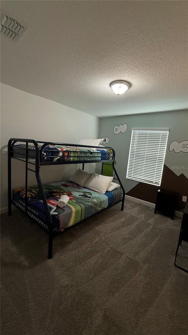 carpeted bedroom with a textured ceiling