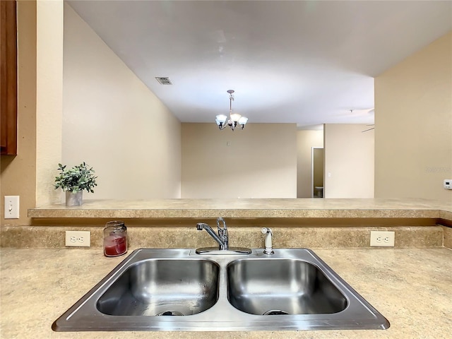 kitchen with a notable chandelier, sink, and decorative light fixtures