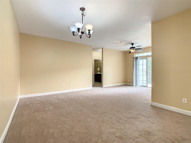 unfurnished room with carpet flooring and ceiling fan with notable chandelier