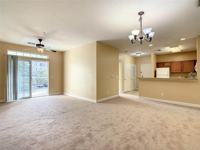 unfurnished living room featuring light carpet and ceiling fan with notable chandelier