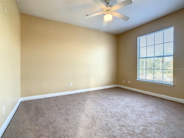 carpeted empty room with ceiling fan