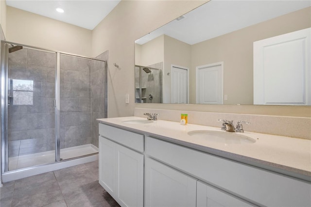 bathroom featuring tile patterned flooring, vanity, and an enclosed shower