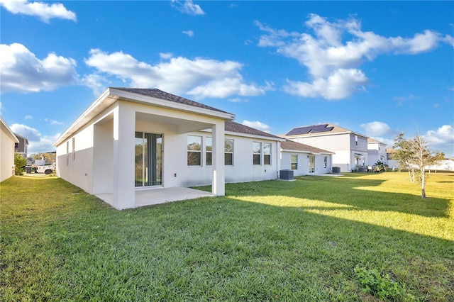 back of property featuring a yard, a patio, and central AC