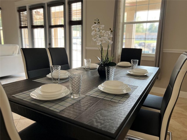 dining space featuring light tile patterned floors