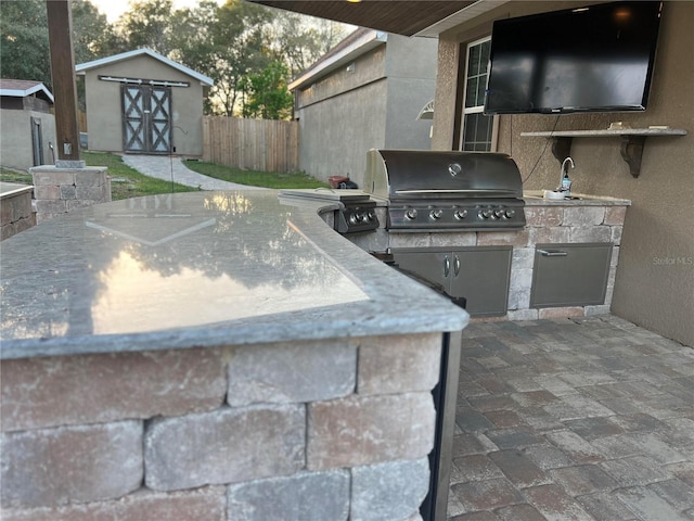 view of patio featuring area for grilling and a grill