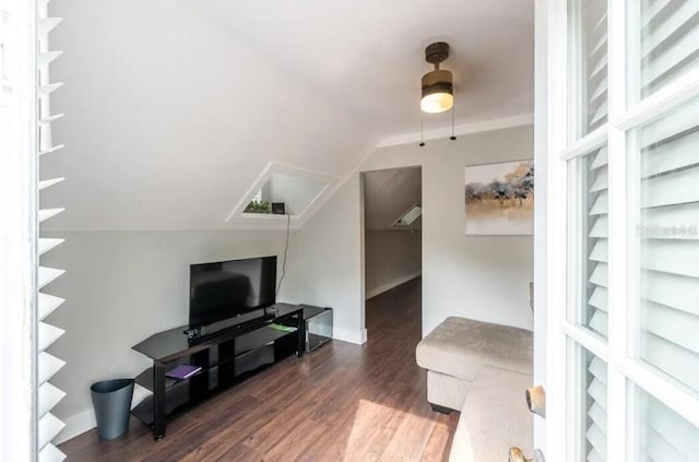 living room with ceiling fan, dark hardwood / wood-style flooring, and lofted ceiling