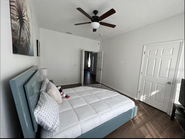 bedroom with wood-type flooring, a textured ceiling, and ceiling fan