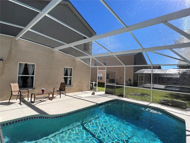 view of pool with a lanai and a patio