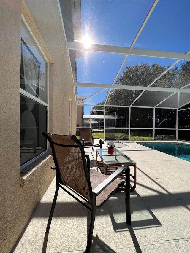 view of patio / terrace featuring glass enclosure