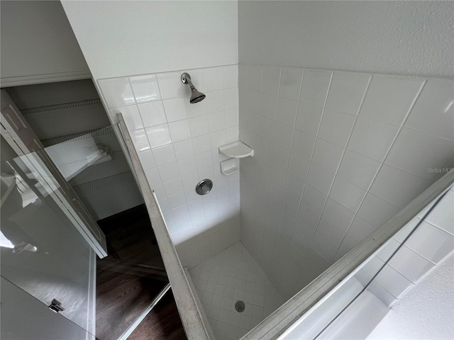 bathroom with tiled shower