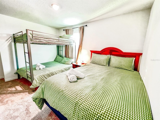 bedroom featuring carpet floors and a textured ceiling