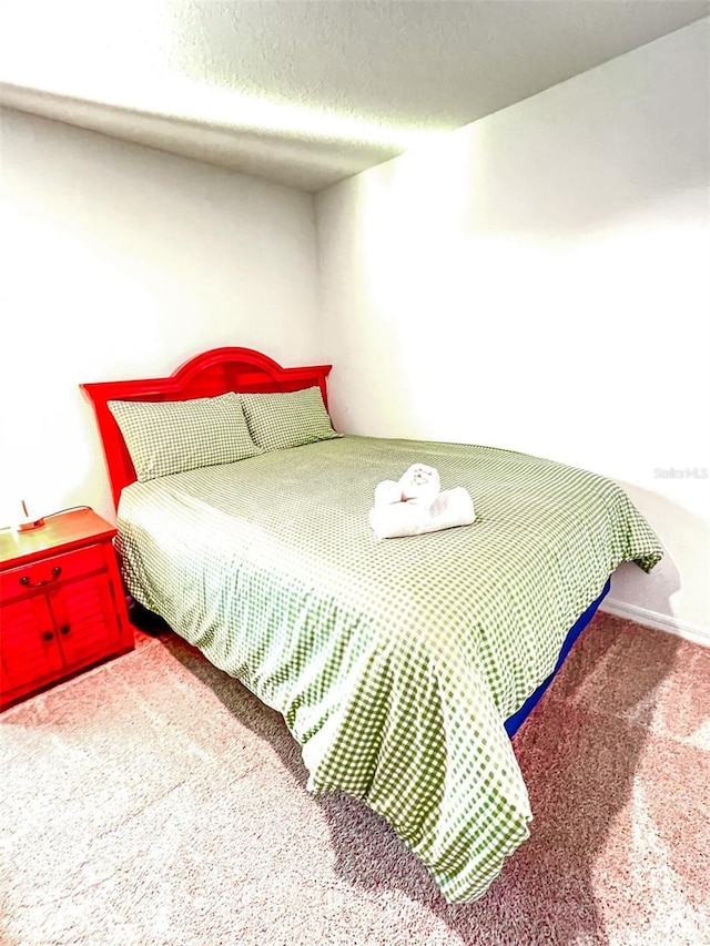 bedroom featuring a textured ceiling and carpet floors