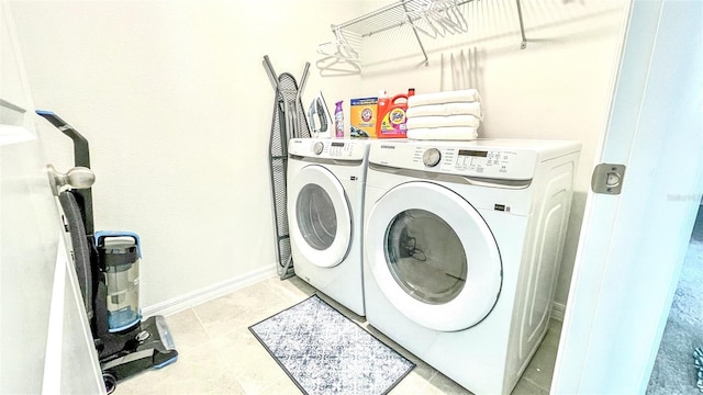 laundry room with washing machine and dryer and light tile patterned floors