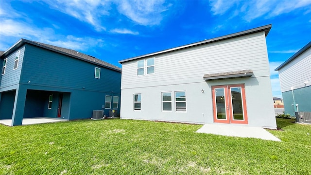 rear view of house featuring a yard, a patio, and central air condition unit