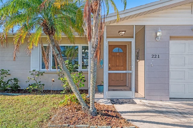 view of exterior entry with a garage