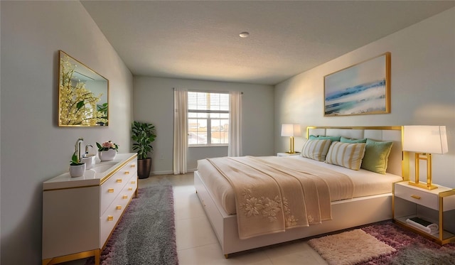 bedroom featuring light tile patterned floors and a textured ceiling