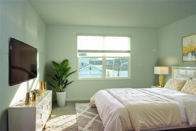 bedroom featuring light colored carpet