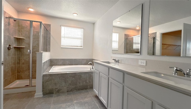 bathroom featuring vanity, tile patterned floors, a textured ceiling, and separate shower and tub