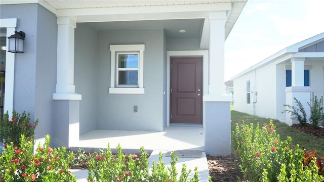 doorway to property with a porch